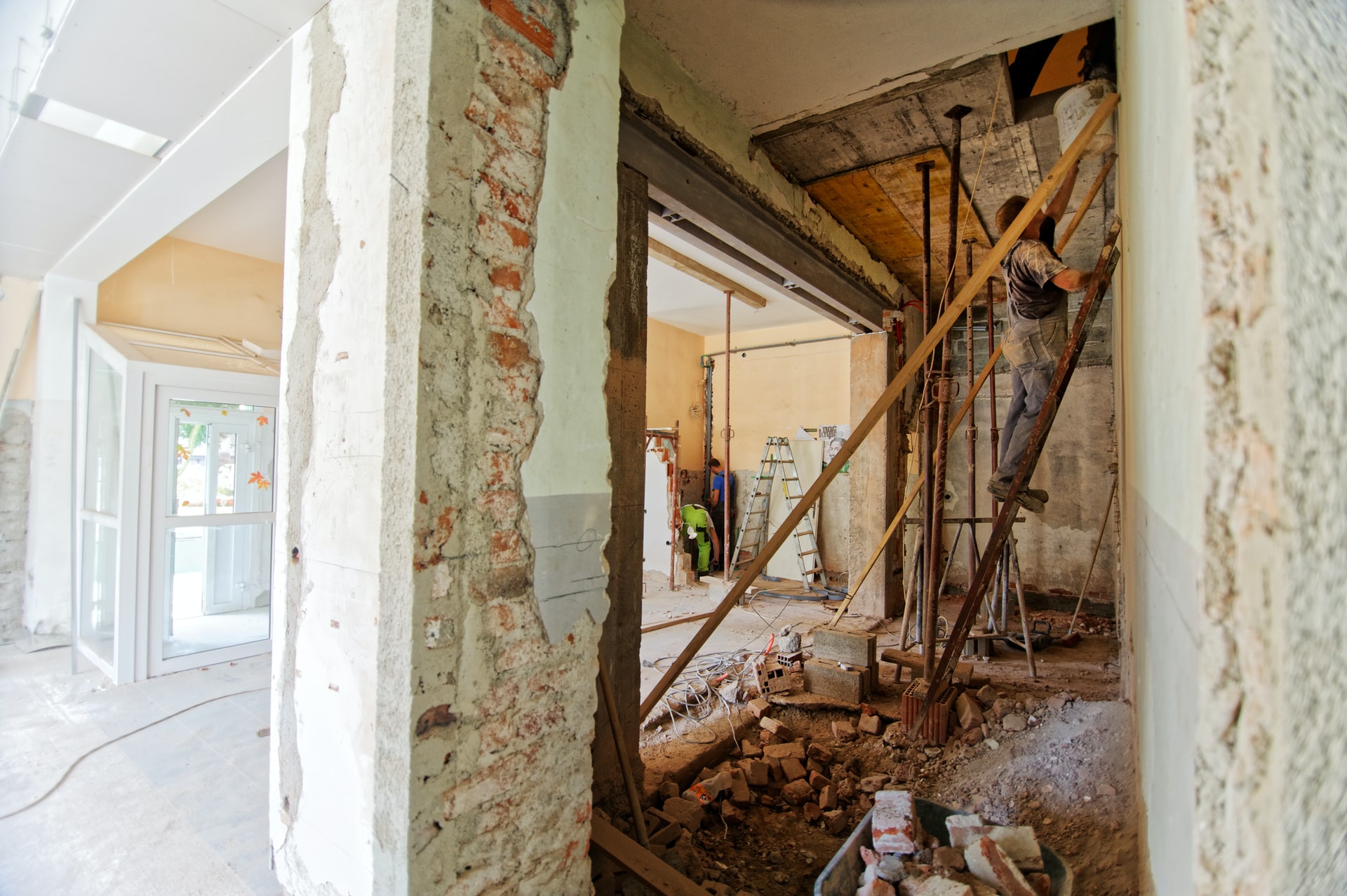 A home project involves remodeling a house with scaffolding and a ladder.